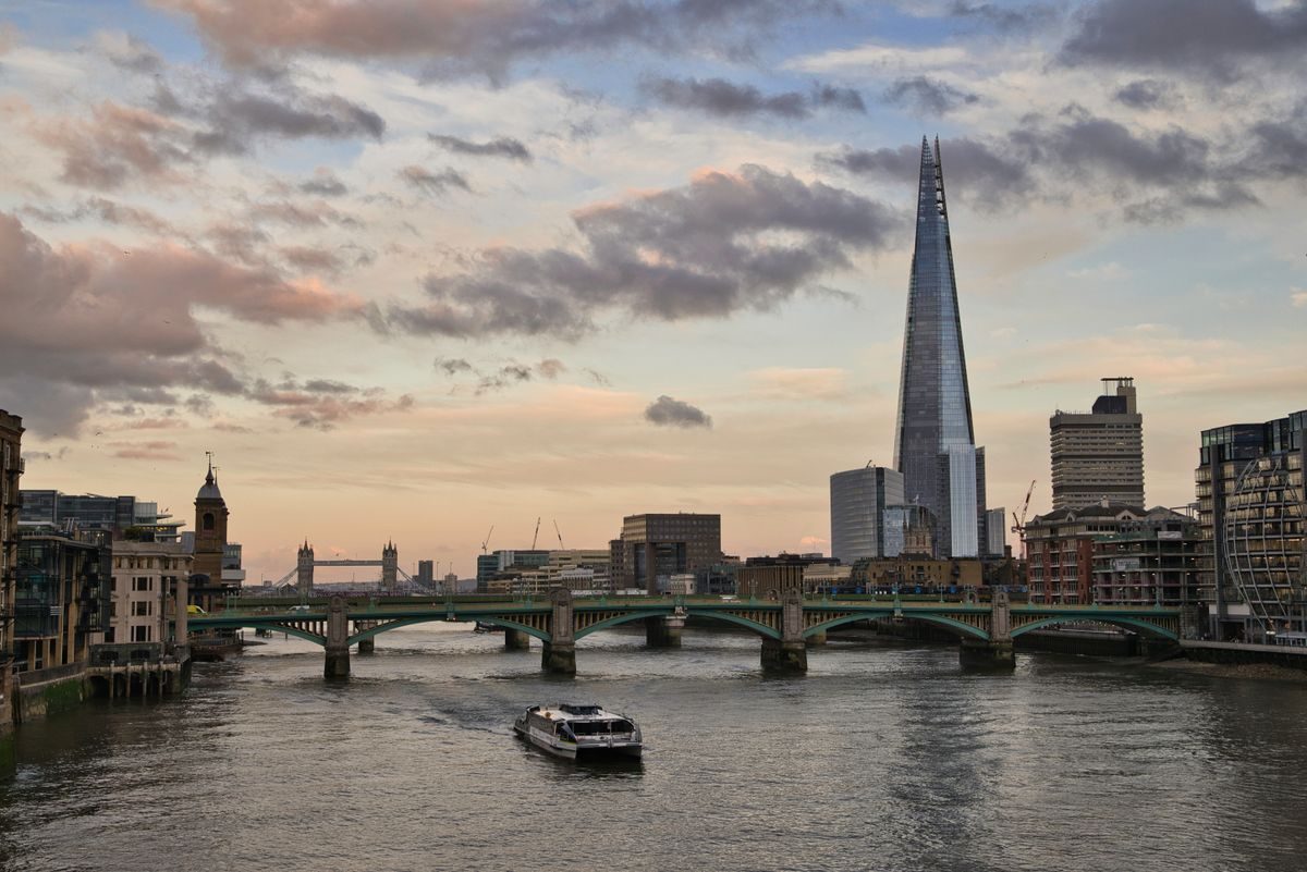 The Thames in London at sunset, with the Shard and Tower Bridge in the background