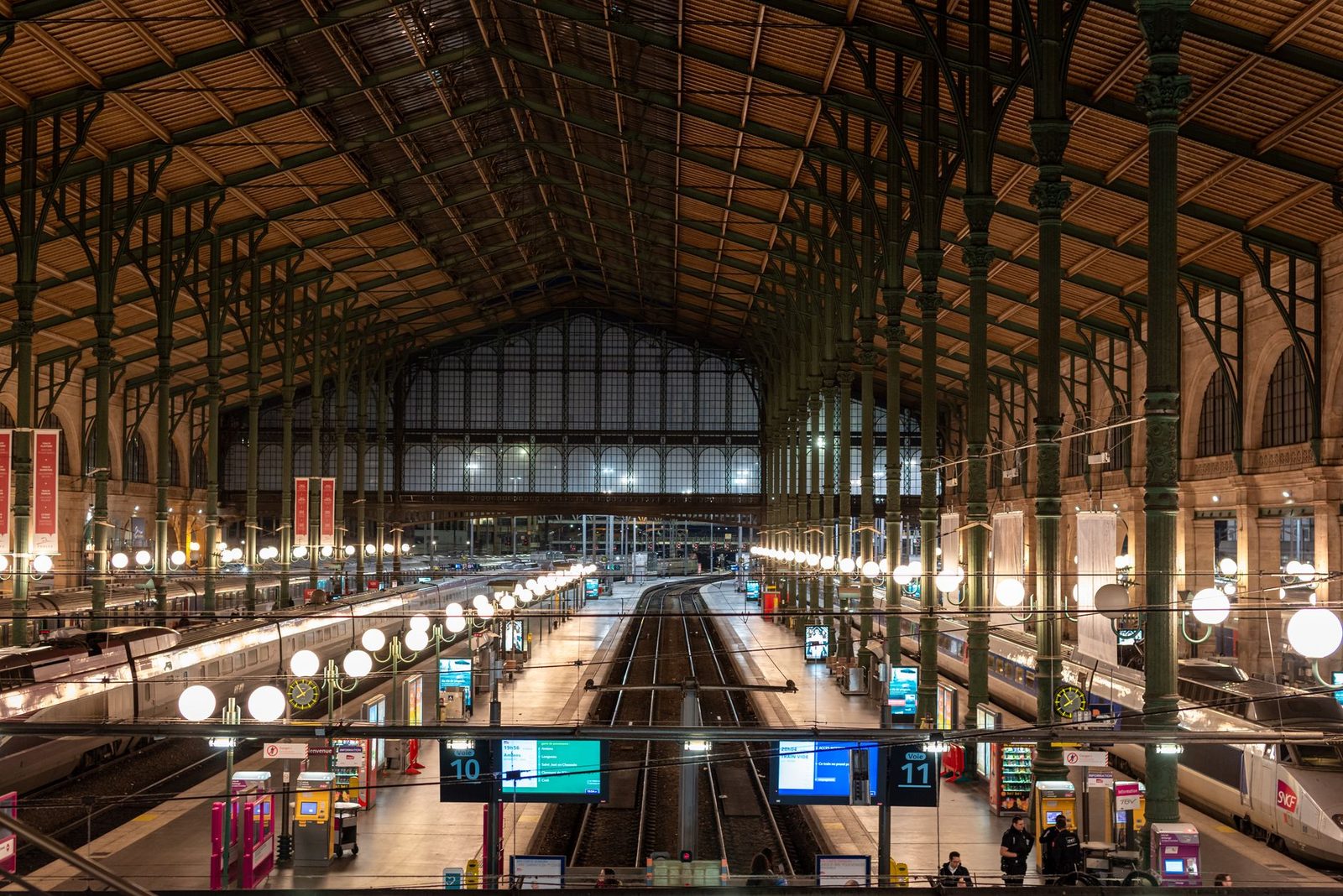 Concourse at Paris Gare du Nord: metal and glass roof, platforms 10 and 11, tracks and TGV trains at a standstill
